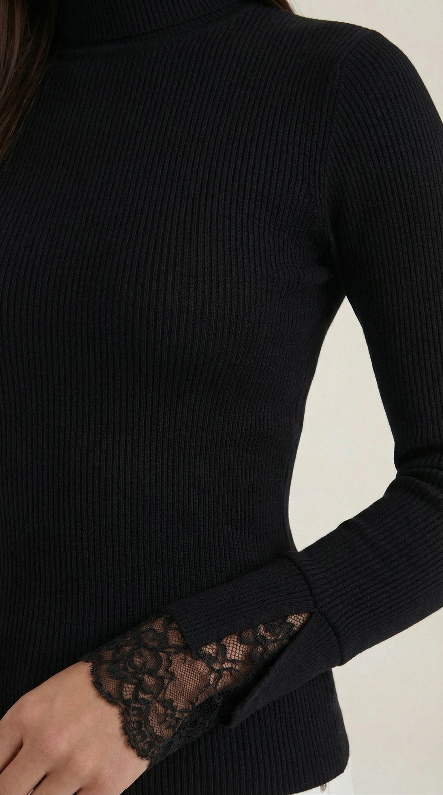 Black ribbed turtleneck sleeve with lace cuff detail and cuff embroidery