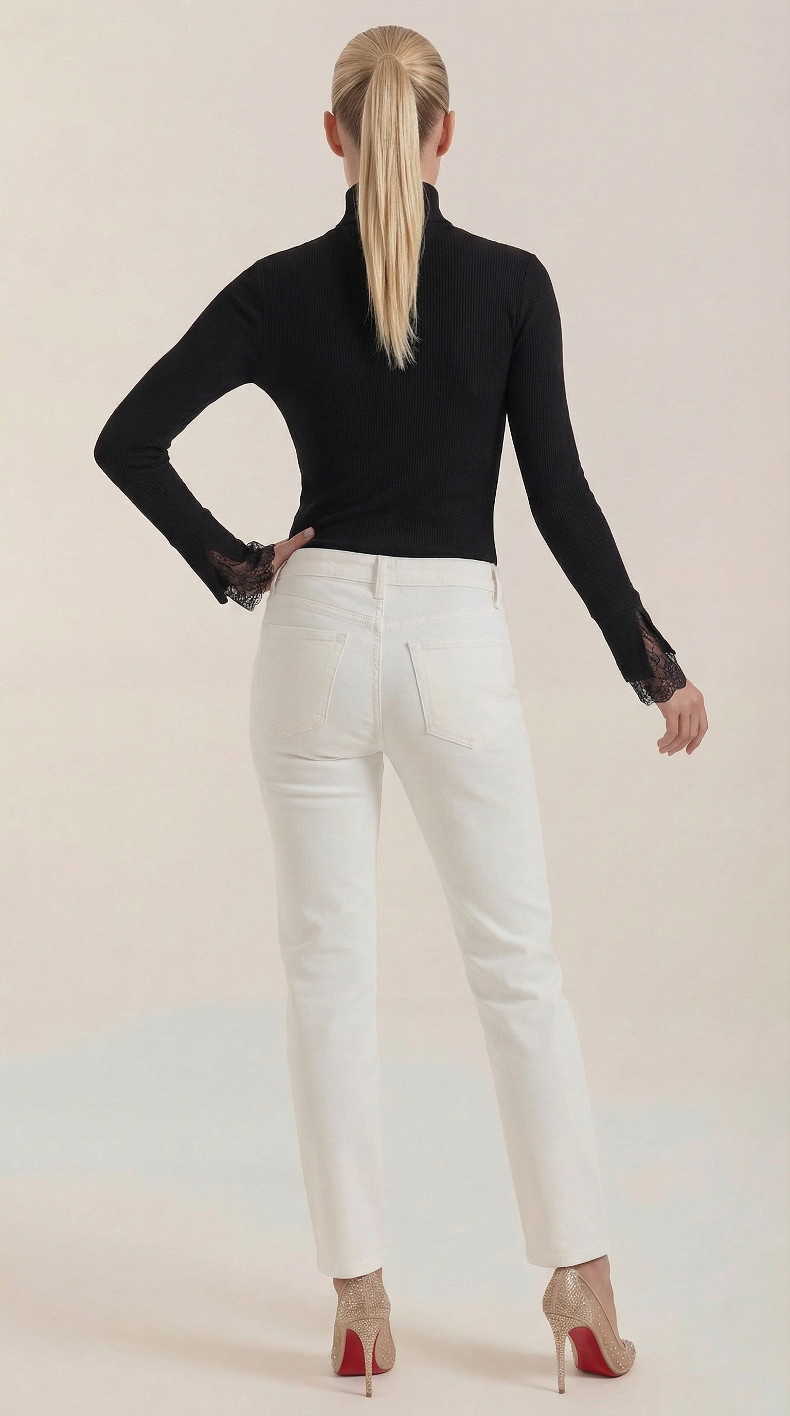 Black ribbed turtleneck top with lace cuff trim on long sleeves, back view