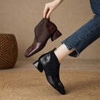 Brown leather square-toe ankle boots with elastic side panels and embossed circular logo