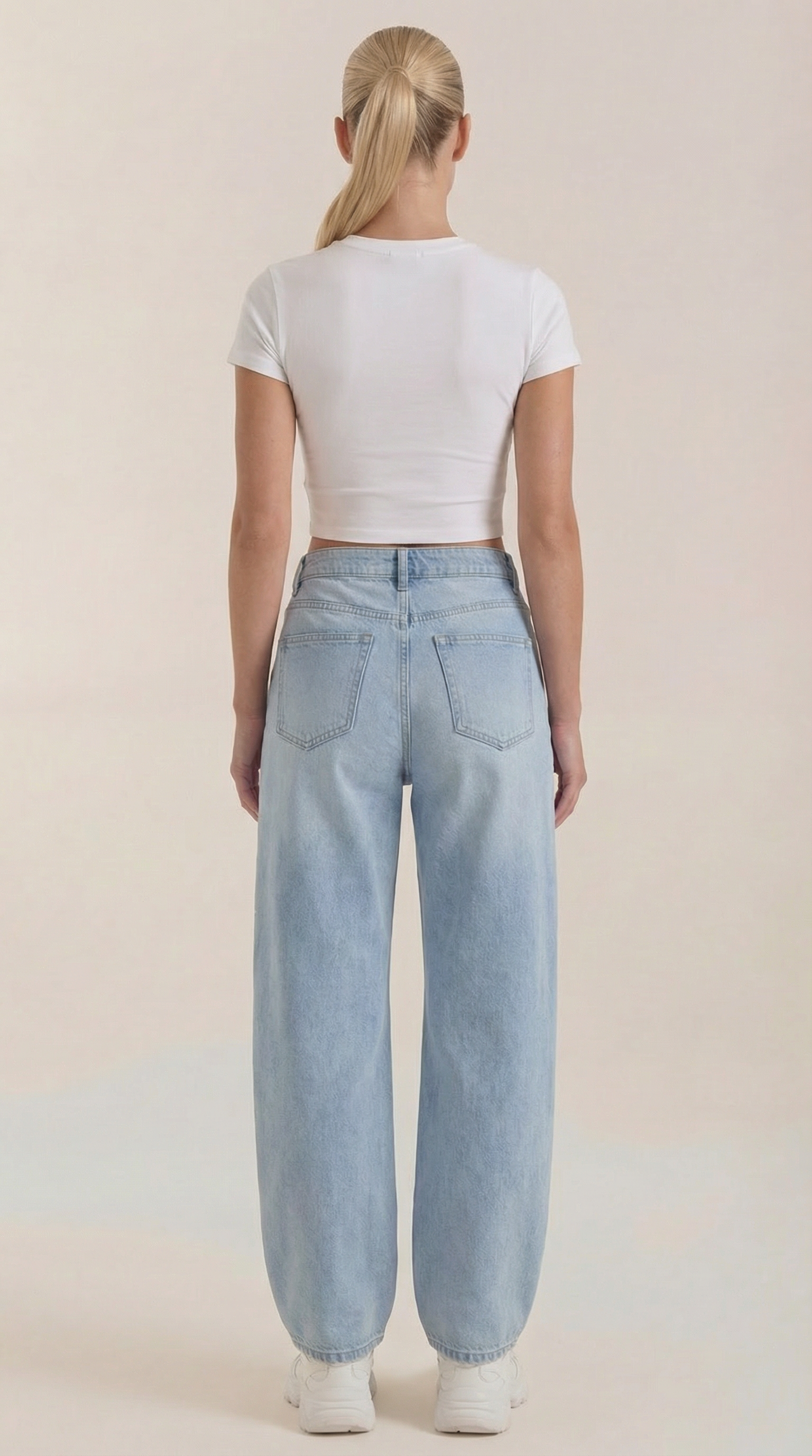 Light blue wide-leg jeans viewed from the back with back patch pockets