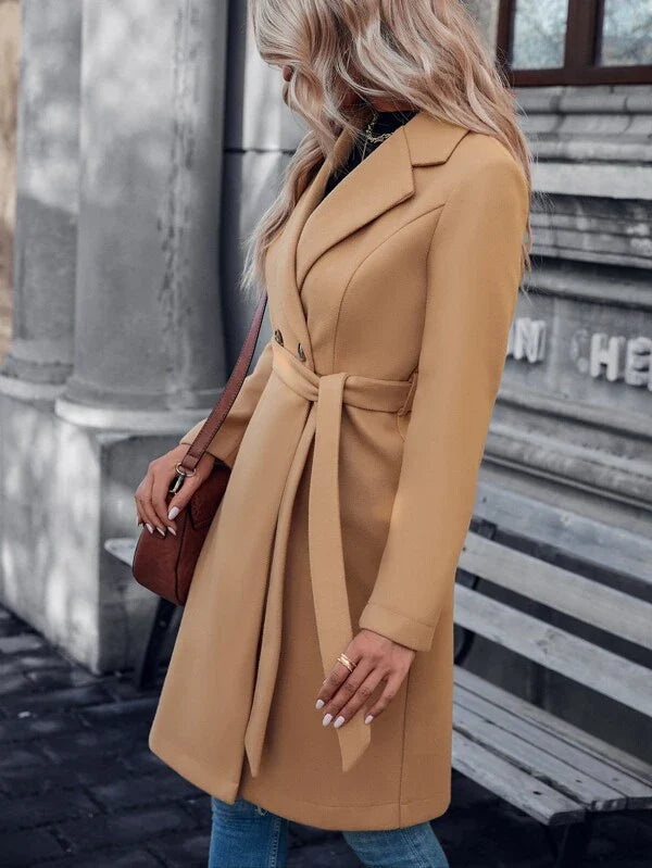 Beige double-breasted A-line coat with belt tie, angled back view, long sleeves