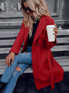 Red double-breasted A-line coat with lapels and tied waist belt, long sleeves