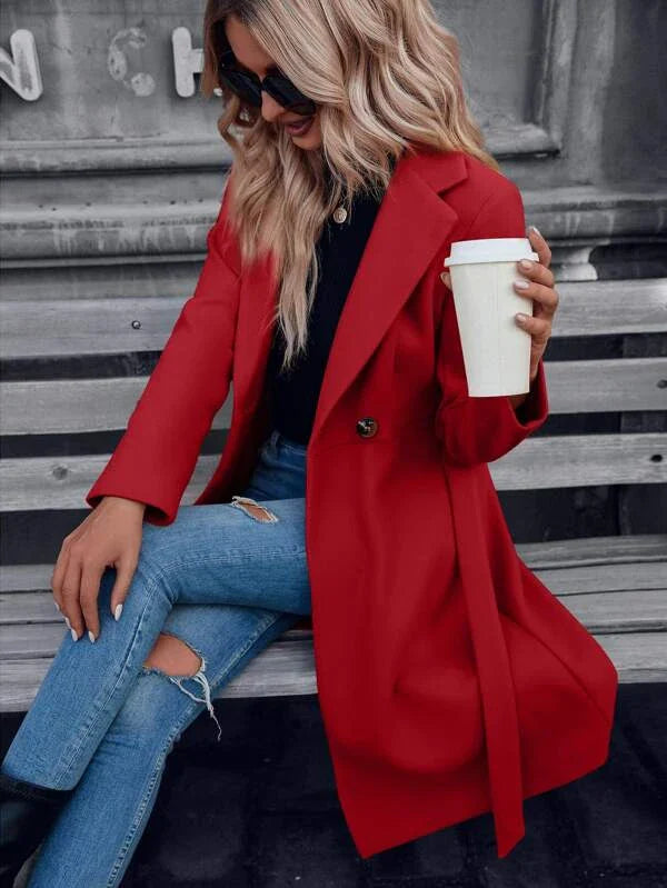 Red double-breasted A-line coat with lapels and tied waist belt, long sleeves