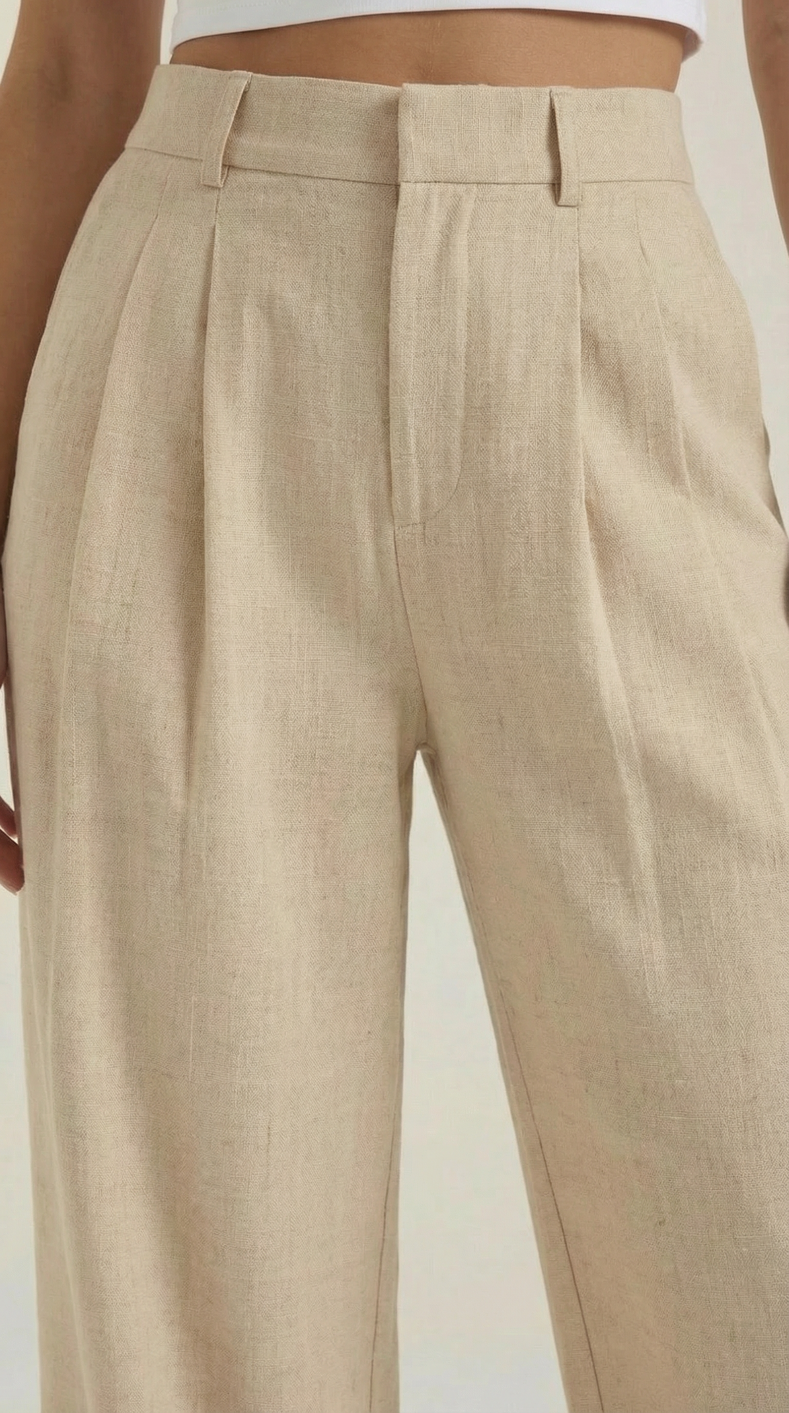Beige pleated high-rise wide-leg pants with belt loops and pleats at the waistband
