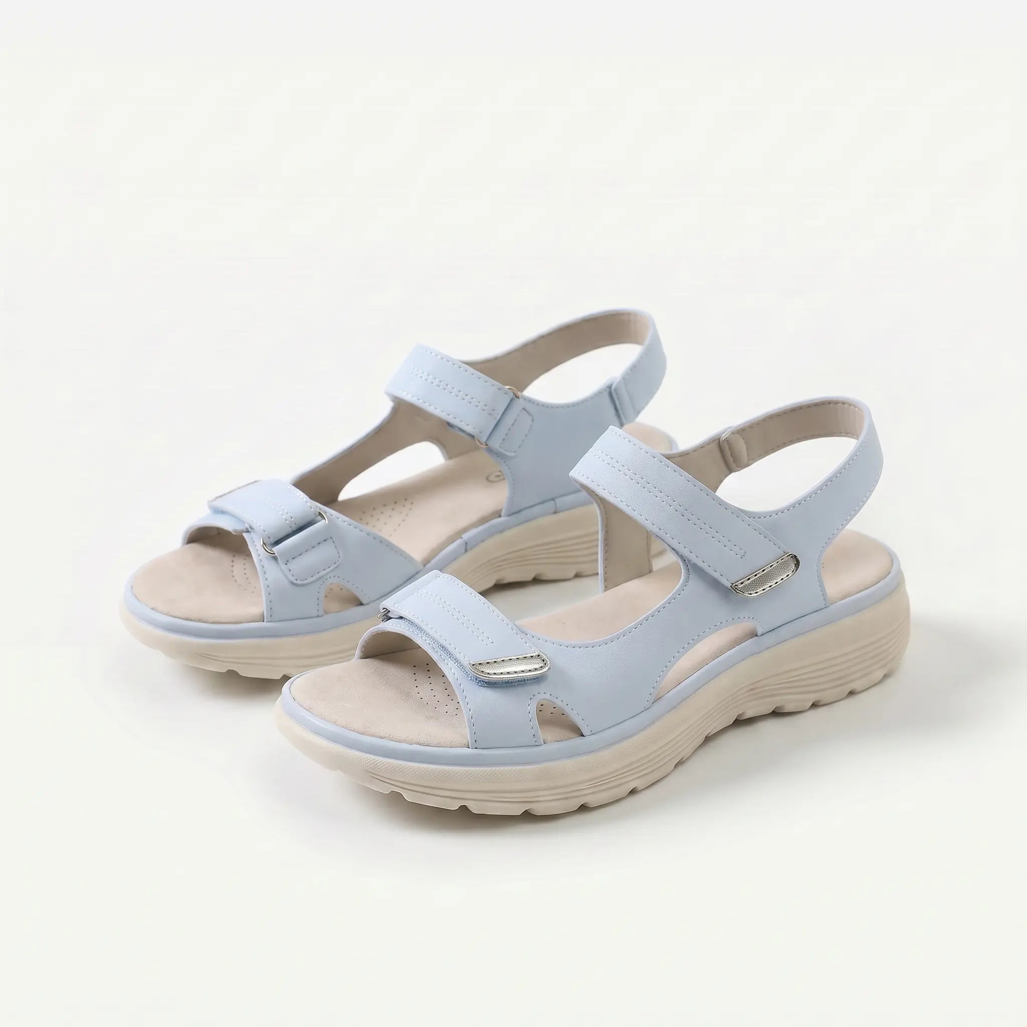Cushioned adjustable casual sandals in light blue with two hook-and-loop closure straps