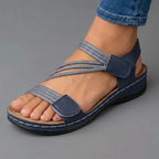 Blue cushioned wedge sandals with dual adjustable hook straps and open toe