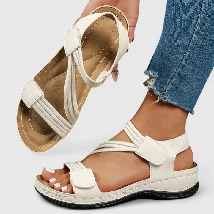 White cushioned wedge sandals with double straps and hook closure, open toe
