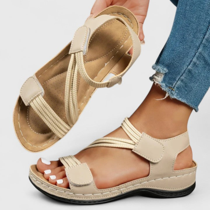 Beige cushioned wedge sandals with double straps and hook closure, open toe