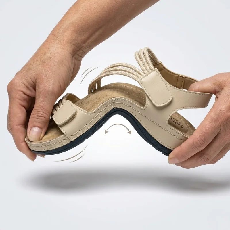 Beige cushioned sandal with hook strap and textured footbed, side view