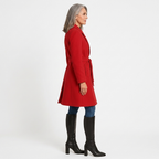 Women’s red double-breasted A-line coat, side view, with belt and flap pockets, lined
