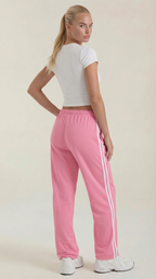 Pink wide-leg track pants with elastic waist, drawstring, and vertical side stripe