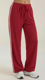 Women’s wide leg track pants in red with white side stripes and drawstring waist