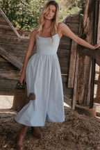 Light blue corset midi dress with thin straps, fitted waist, and gathered full skirt