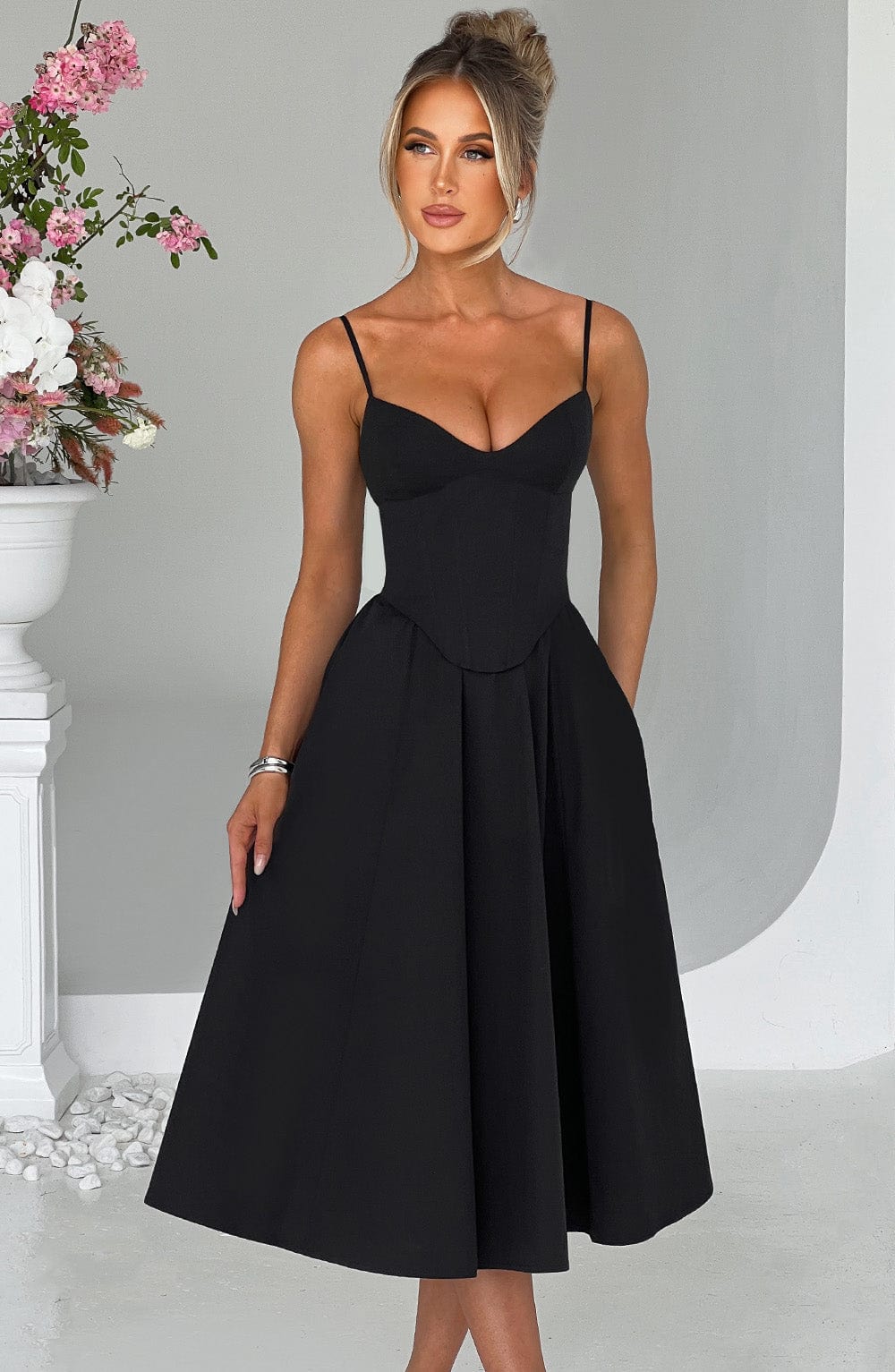 Black corset midi dress with spaghetti straps and sweetheart neckline, pleated skirt