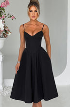 Black corset midi dress with spaghetti straps and corset-style waist, flared pleated skirt