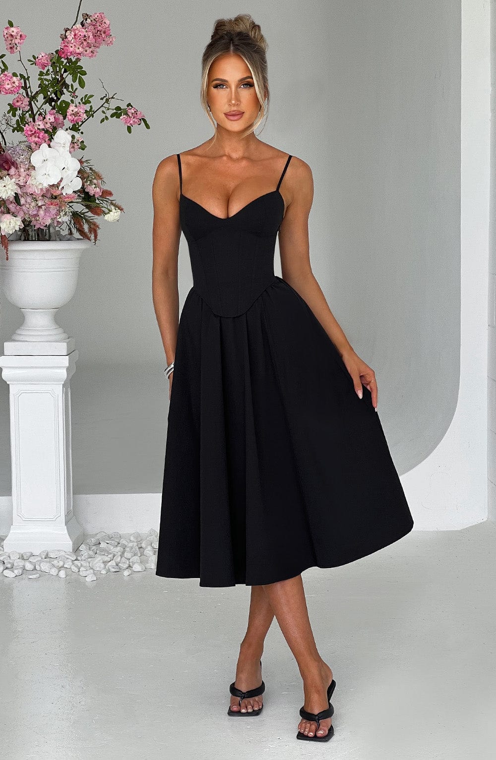 Black corset midi dress with spaghetti straps and sweetheart neckline, gathered pleated skirt