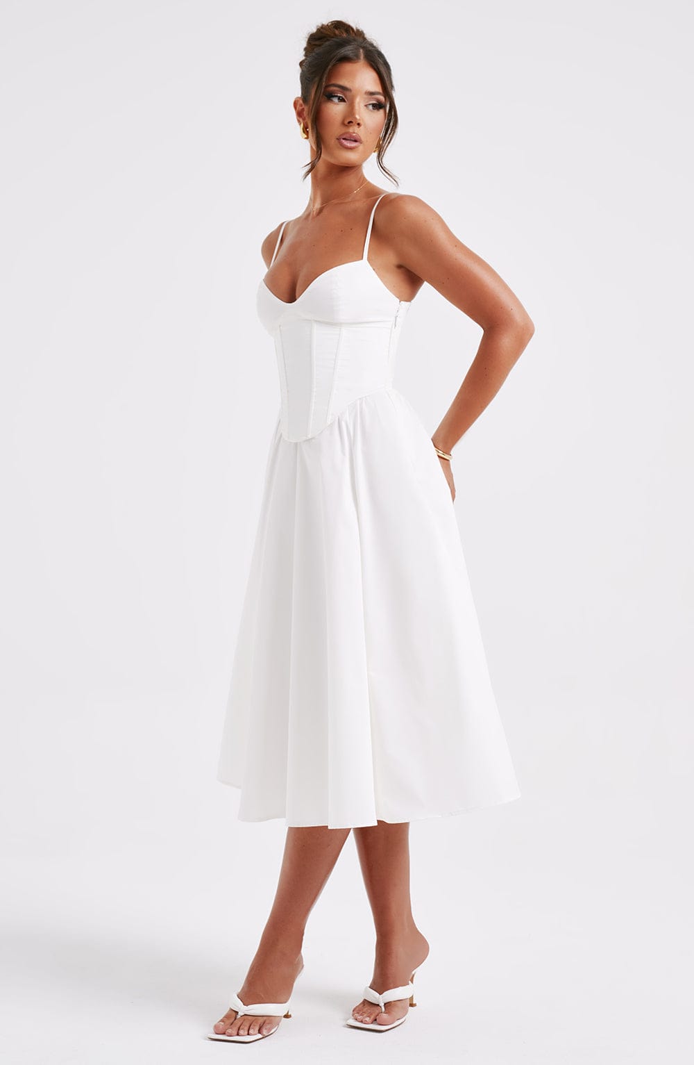 White corset midi dress with spaghetti straps and sweetheart neckline, flared skirt