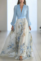 Light blue V-neck maxi dress with long puff sleeves and blue floral printed skirt.