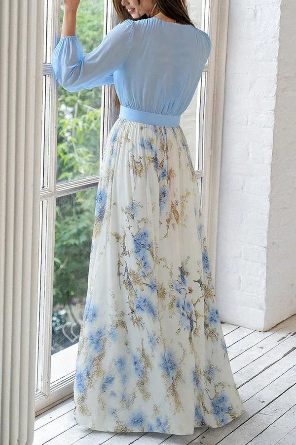 Light blue V-neck maxi dress with long sleeves and draped blue floral A-line skirt.