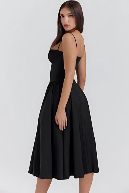Black A-line midi dress with spaghetti straps and pleated skirt, side view