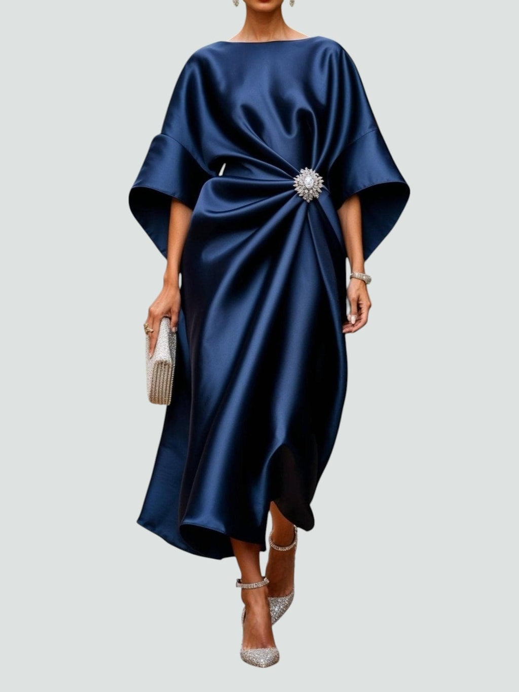 Navy satin cape-sleeve maxi dress with draped waist and silver crystal brooch