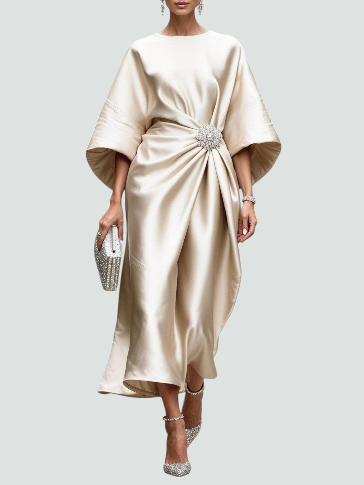 Cream satin cape-sleeve maxi dress with draped waist and silver crystal brooch