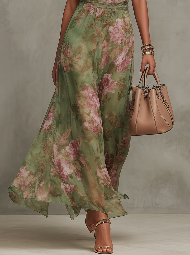 Women’s halter maxi dress skirt detail, green floral print, lightweight flowy fabric.