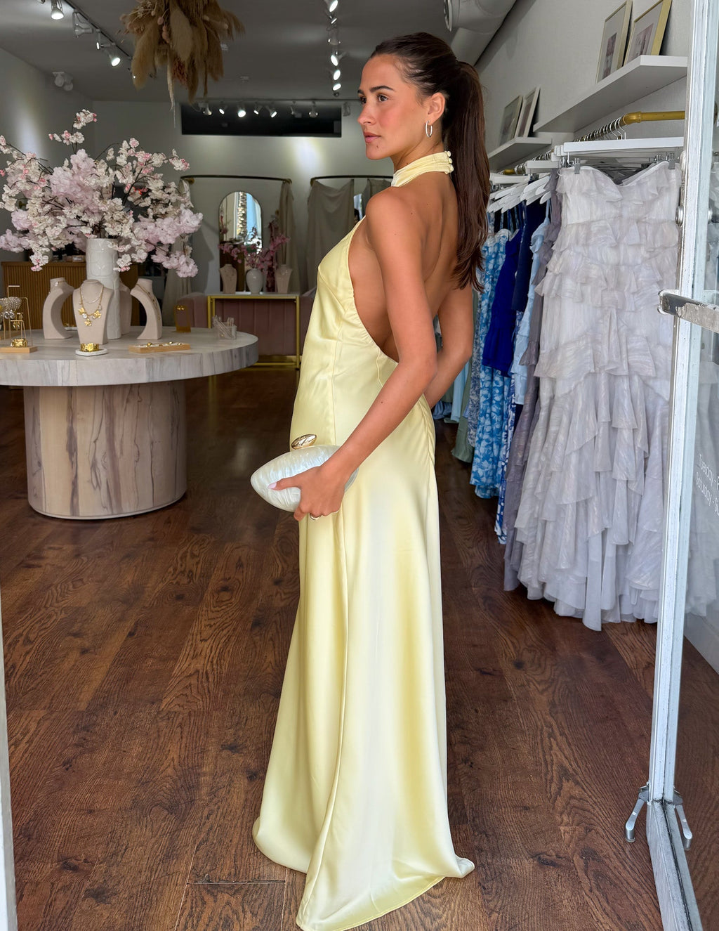 Yellow satin halter neck maxi dress from side view, backless open style and long hem