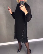 Black midi shift dress with button-front, sheer polka-dot sleeves, and midi ruffle hem