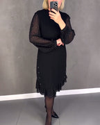 Black midi shift dress with sheer polka-dot long sleeves and softly ruffled hem