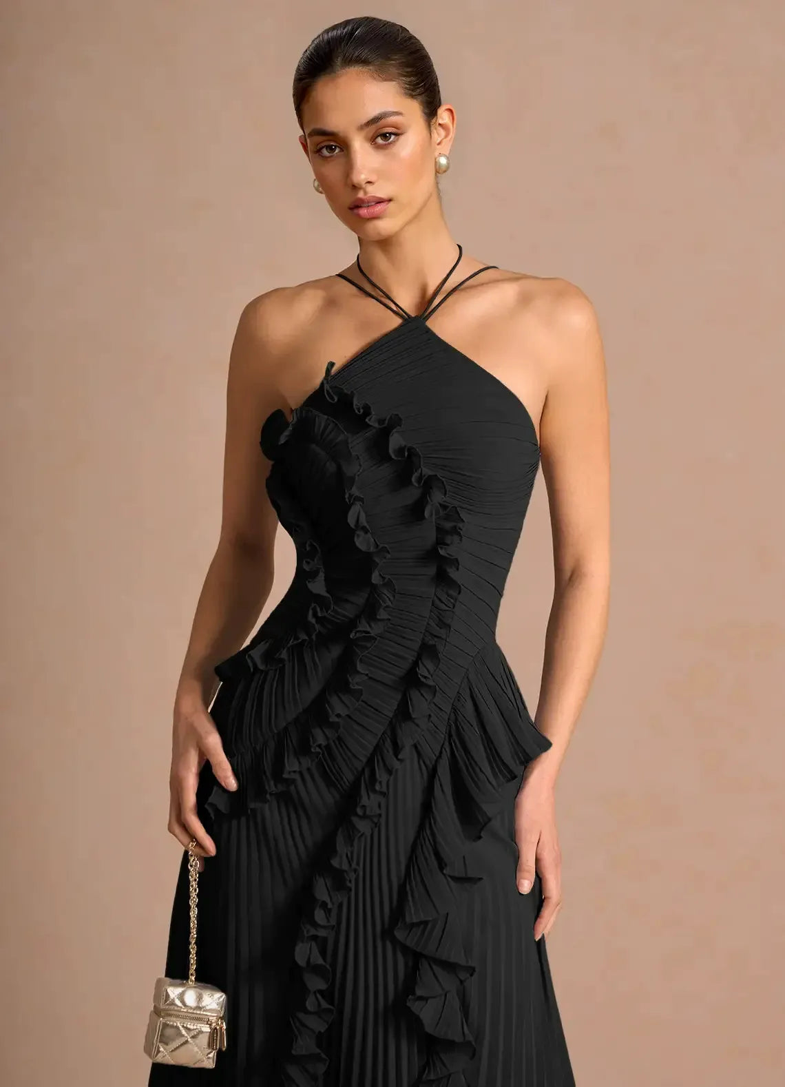 Black spiral ruffle halter dress with crisscross straps and tiered ruffle skirt