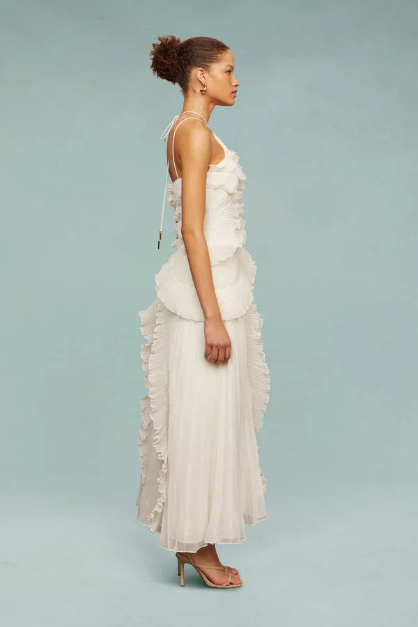 Back view of white ruffle halter dress with layered spiral tiers and flowing skirt