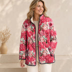 Pink floral quilted jacket with black trim, snap-front and stand collar detail