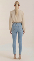 Beige draped long-sleeve blouse back view with gathered shoulders and cowl neck