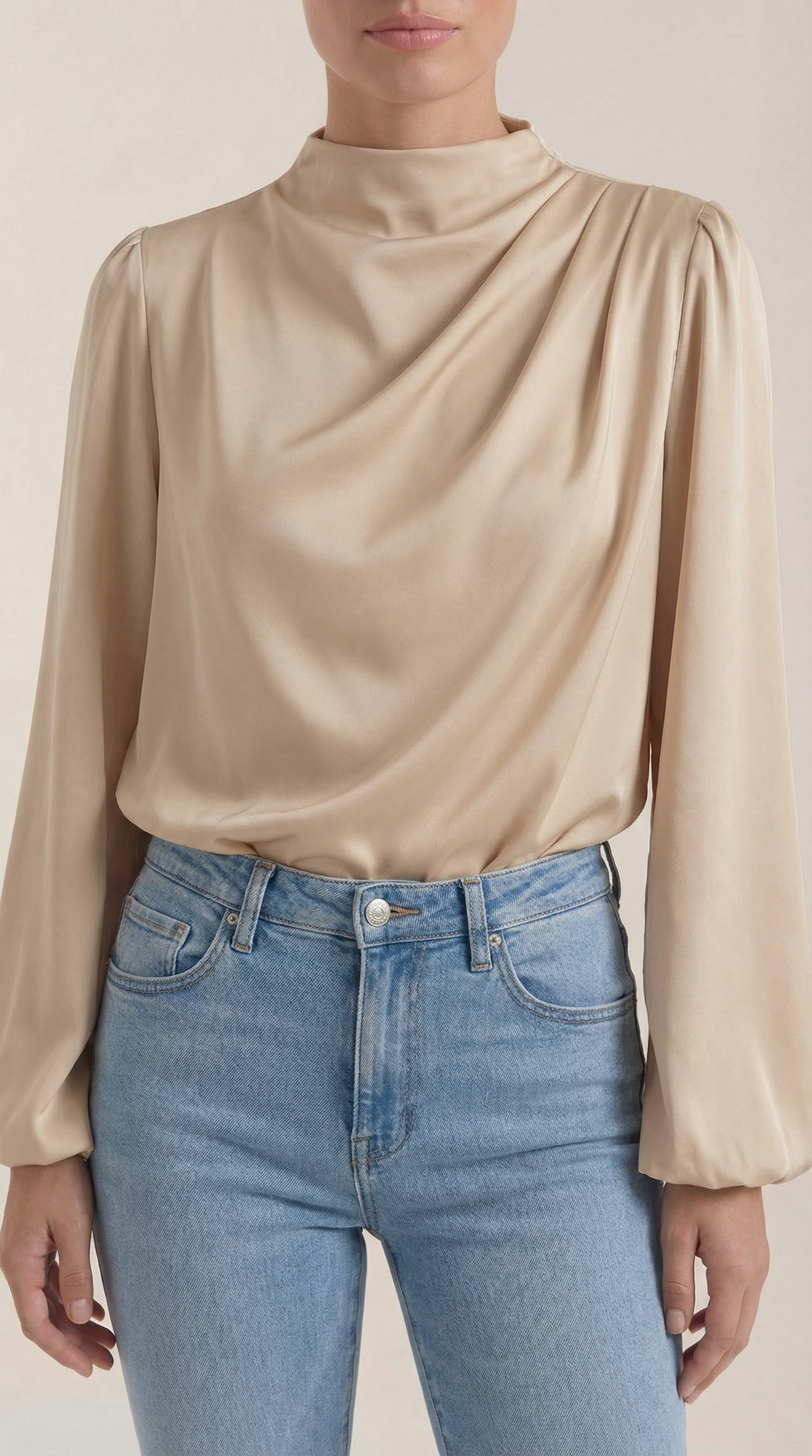 Beige draped long-sleeve blouse close-up of cowl neckline and shoulder gathers