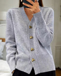 Grey knit V-neck cardigan with gold heart buttons and ribbed cuffs and hem