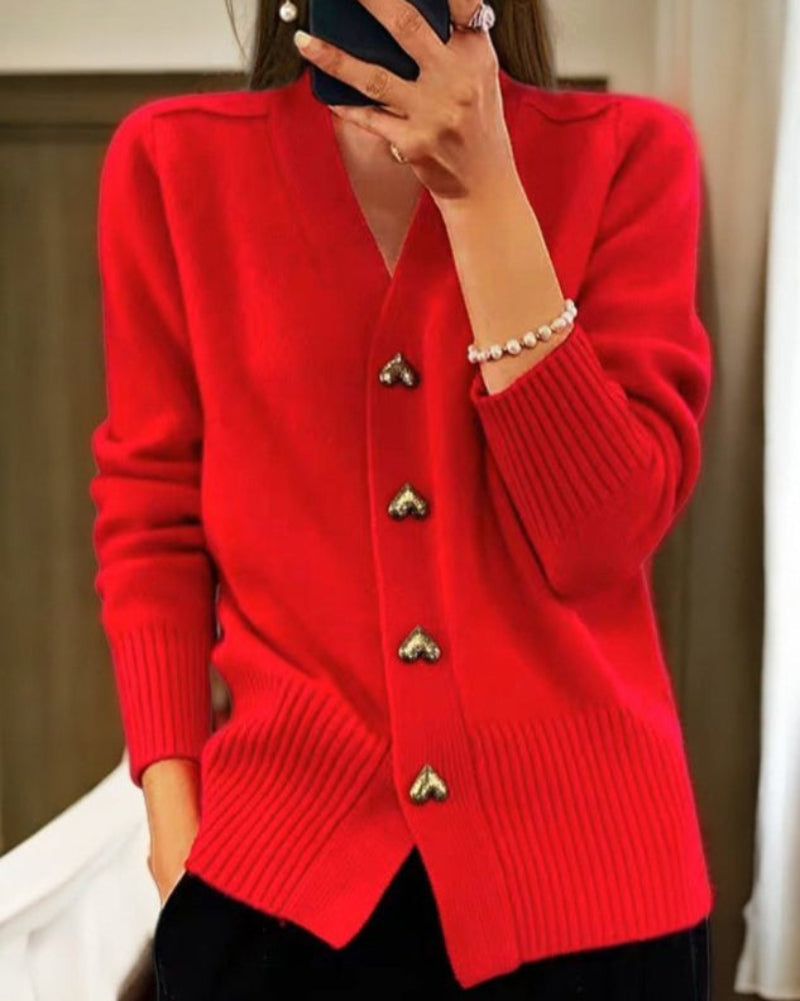 Red knit V-neck cardigan with gold heart buttons and ribbed cuffs and waistband