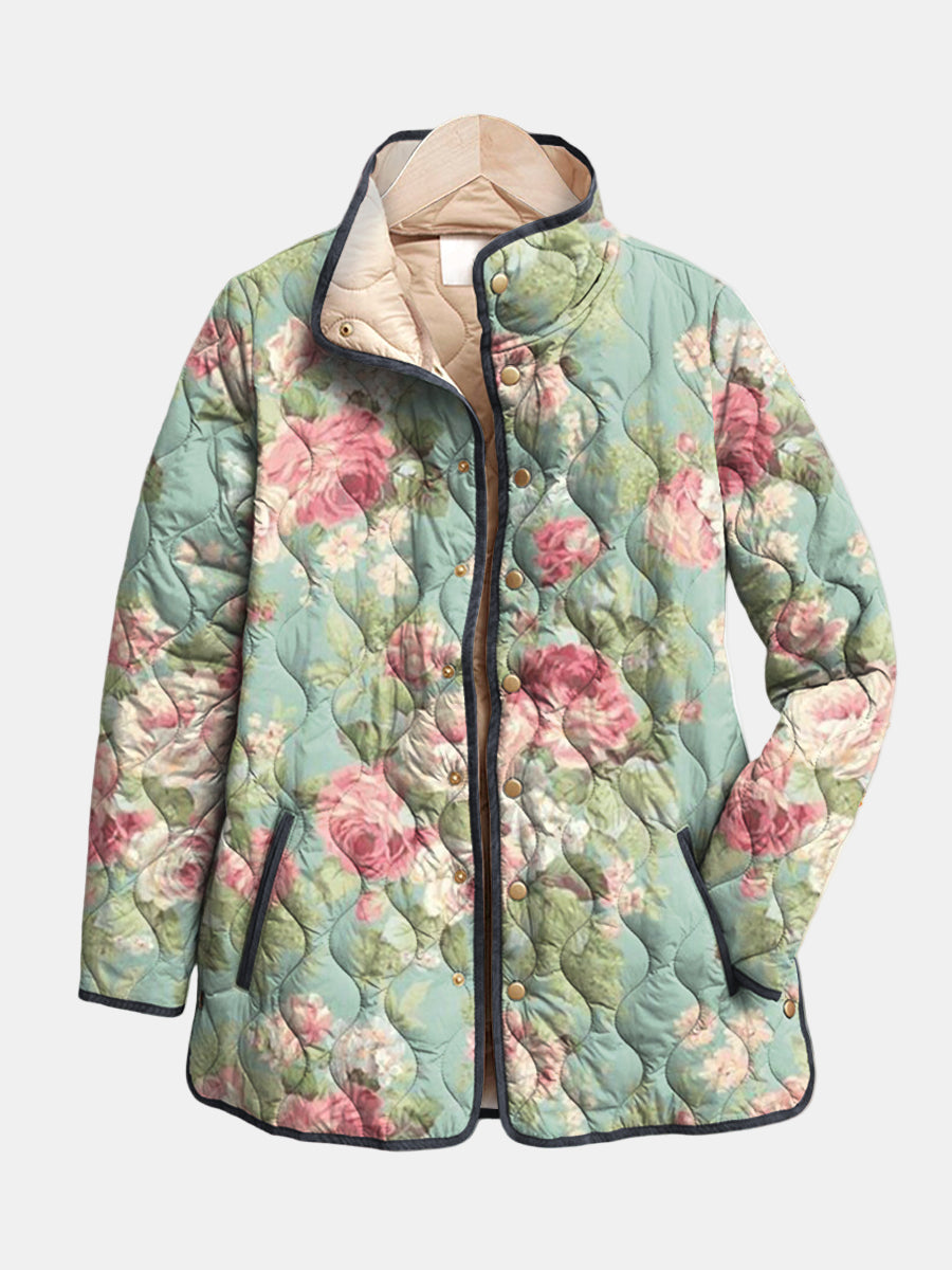 Lightweight quilted floral jacket in teal with pink rose print, black trim, snap buttons