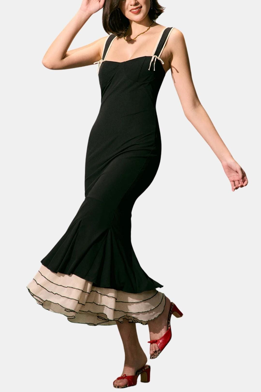 Black sleeveless fishtail midi dress with spaghetti straps and ruffle hem detail