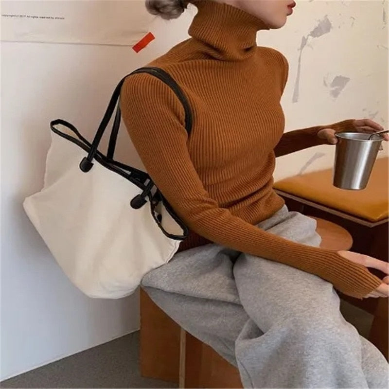 Women’s ribbed turtleneck sweater, rust brown, long sleeves, fitted stretch knit.