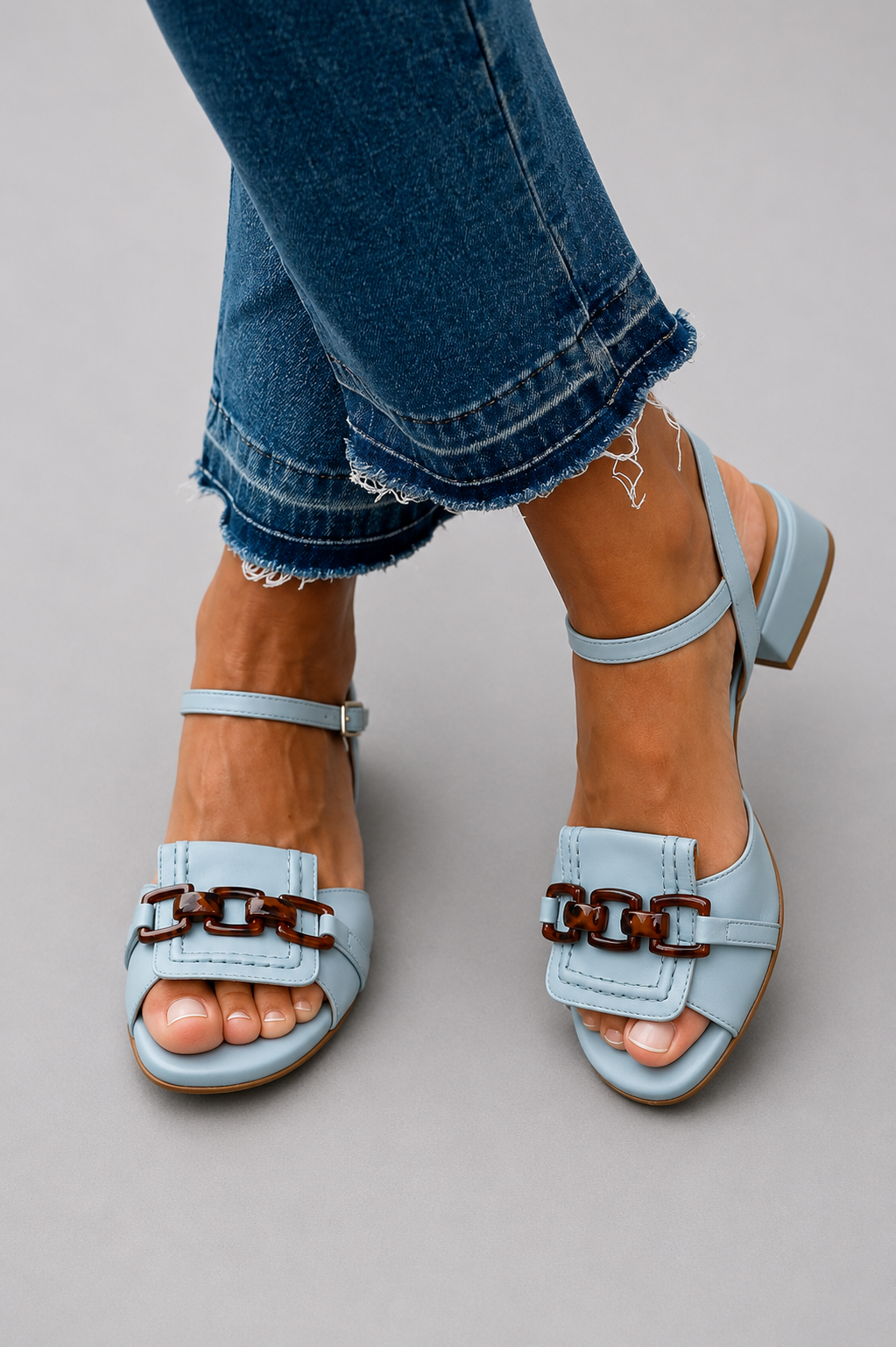 Light blue heeled sandals with two strap buckles and open toe