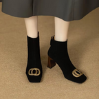 Black velvet ankle boots with block heel and gold O-ring buckle on side