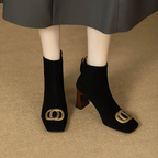Pair of black velvet ankle boots with gold O-ring buckle and block heel
