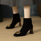 Black velvet ankle boots with block heel and gold O-ring buckle detail