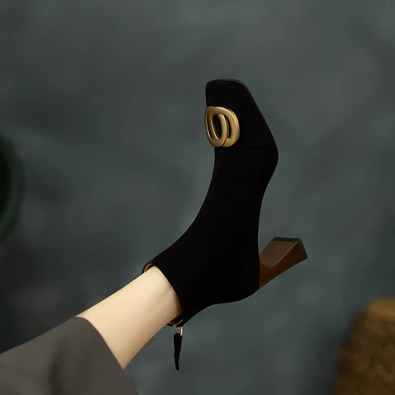 Black velvet ankle boot with gold O-ring buckle and chunky block heel