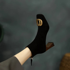 Black velvet ankle boot with gold O-ring buckle and chunky block heel