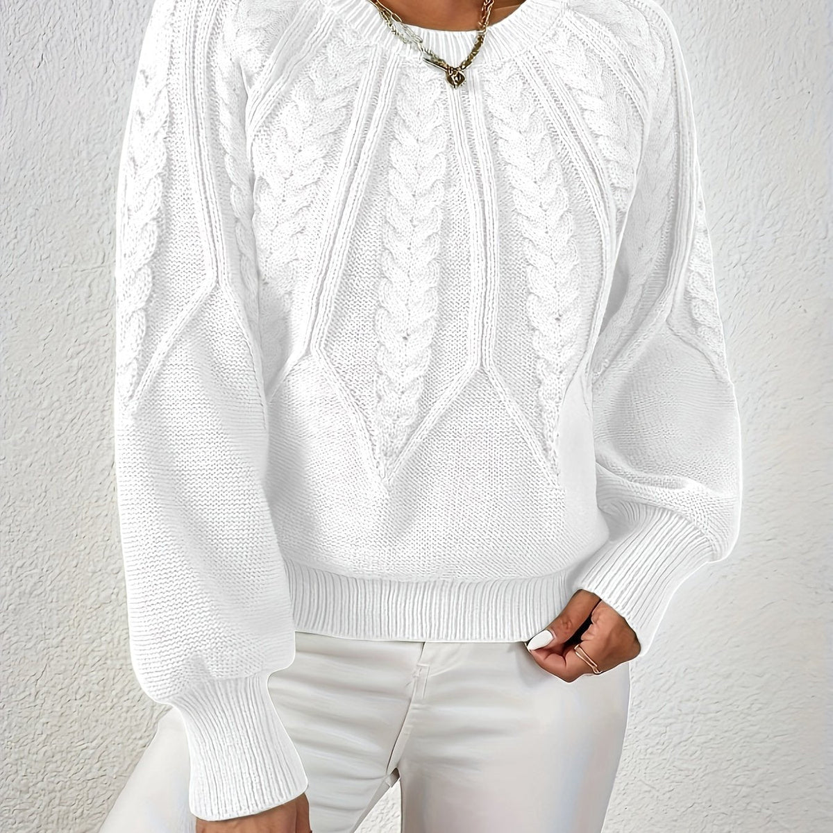 White cable knit sweater with voluminous sleeves, textured cable diamond pattern, zip neck