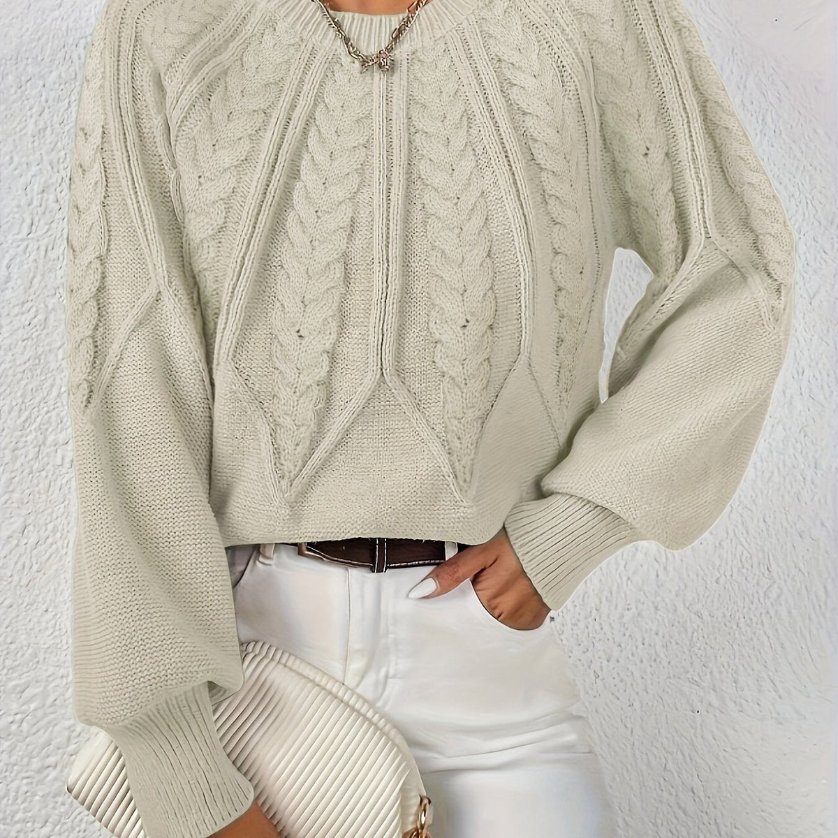 Beige cable knit sweater with voluminous sleeves, textured cable diamond pattern, zip neck
