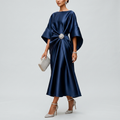 Navy satin cape-sleeve maxi dress with draped waist and silver crystal brooch