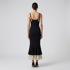 Black fishtail midi dress back view with spaghetti straps and layered ruffle hem